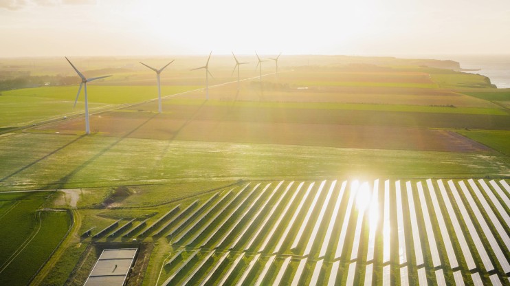 solar farm wind turbines sunrise