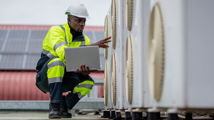 Worker inspecting HVAC unit