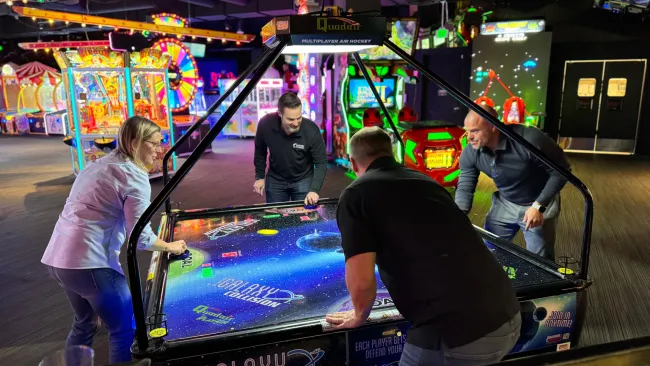 leadership playing air hockey