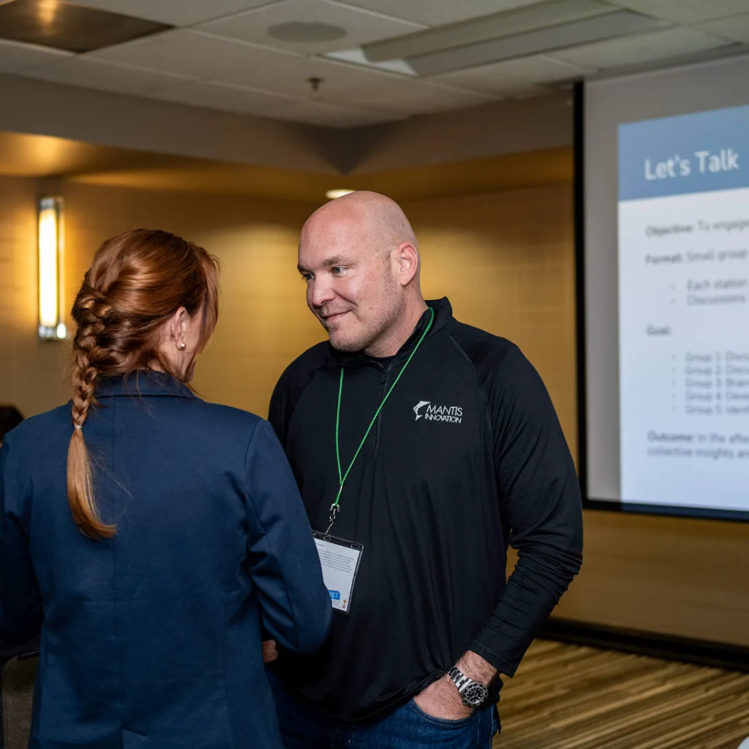 two mantis team members talking